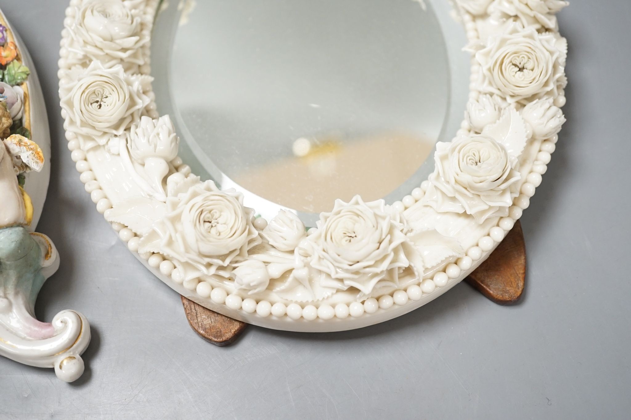 Two German porcelain easel mirrors and a Belleek easel mirror, tallest 43cm